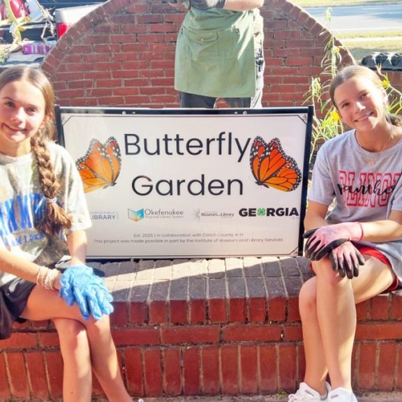 Above are Bristol Thomas and Kathryn Daniel in the butterfly garden at the Clinch County Public Library. Below are Bristol and Kathryn working in the garden.